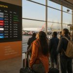 Flight booking in Kenya at Jomo Kenyatta International Airport with travellers preparing for departure.